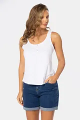 Musculosa azul con estampado de formas geométricas en blanco, escote redondo y botones decorativos en el frente.