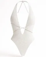 Malla entera blanca de encaje con forro blanco, corte cavado y espalda descubierta.