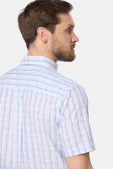 Camisa celeste y blanca a cuadros de manga corta con botones personalizados. Hecha en Uruguay.