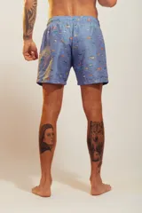 Bañador de hombre color rosa pálido con estampado de golondrinas oscuras. Presenta cintura elástica con cordón ajustable de color crudo y terminales turquesa.