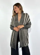 Saco largo de tejido de punto con rayas verticales en tonos beige y gris. Tiene cuello shawl y mangas largas.
