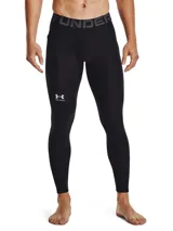 Calza larga de compresión Under Armour HeatGear, color negro con logo estampado en blanco en la pierna derecha y cintura elástica con la inscripción "Under Armour" en gris.