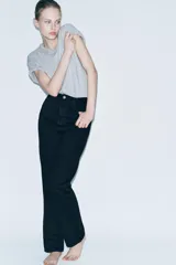 Pantalón de jean negro de tiro alto, corte slim y largo hasta el tobillo.