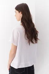 Blusa color salmón de lino con escote en V y mangas cortas.