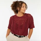 Camiseta de manga corta color borgoña, confeccionada en tejido de encaje floral.