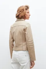 Chaqueta biker de eco cuero beige con cortes en tul y cierre frontal.