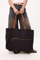 Bolso tote negro de algodón con asas marrones y logo "beganesha" estampado en marrón.