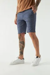 Bermuda de gabardina color beige, corte chino, con bolsillos laterales y traseros, cierre con cremallera y botón, presillas para cinturón y logo bordado.