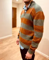 Sweater tejido en lana con técnica intarcia, con cuello alto con cierre parcial y diseño a rayas horizontales en tonos naranja y verde. Corte clásico.