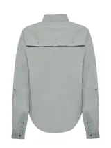 Camisa de manga larga color gris claro, con cuello camisero, cierre frontal con botones y dos bolsillos con solapa en el pecho. Confeccionada en algodón orgánico con protección solar UPF 50+.