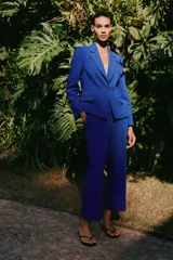Pantalón de vestir azul eléctrico, de tiro alto, con bolsillos delanteros y falsos bolsillos de vivo en la espalda. Pierna recta con vuelta en el bajo.