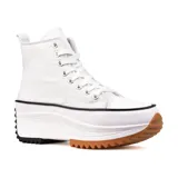 Zapatillas deportivas de caña alta color blanco con suela gruesa de goma color caramelo y detalles en negro.