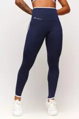 Calza deportiva azul marino con cintura alta y detalles en blanco en cintura y laterales.
