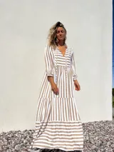 Vestido largo tipo túnica con rayas verticales color beige y crudo, escote en V con lazos y mangas 3/4.