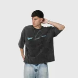 Remera de algodón 100% con efecto acid wash gris oscuro y estampado en la espalda con el logo "Venefo" en celeste, junto con texto que dice "Industries Company | 004®1994 Worldtribe Co".