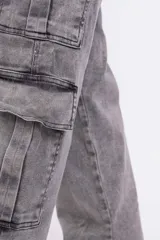 Pantalón cargo gris con efecto lavado, de corte recto y tiro alto. Presenta bolsillos laterales con fuelle y trabillas para cinturón.