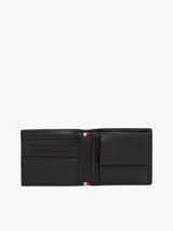 Billetera Tommy Hilfiger de cuero granulado color negro, con diseño plegable, múltiples ranuras interiores para tarjetas, bolsillo interior para monedas y logo metalizado en la parte delantera.