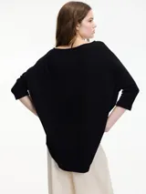 Sweater color crema de mangas 3/4, fit amplio y largo más largo en la parte trasera.