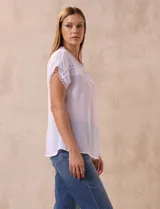Blusa blanca de gasa marca Palm Rio, con cuello a la base y manga corta japonesa. Aplique de crochet en cuello, ruedo de manga y delantera.