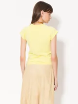 Musculosa amarilla con estampado de hongos en tonos lila y detalle de paisaje en la parte inferior.