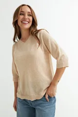 Sweater color beige de tejido de punto, con escote en V y mangas 3/4.