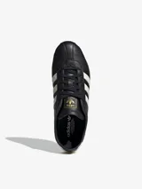 Zapatillas Adidas Tokyo negras con detalles en blanco y suela marrón.