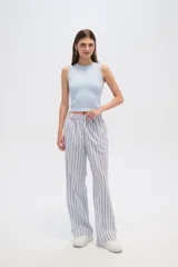 Pantalón de algodón a rayas verticales celestes y blancas, de corte holgado y tiro alto.