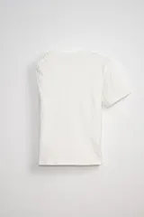 Remera blanca de algodón con estampado asimétrico en el frente y detalle de nudo en el hombro.