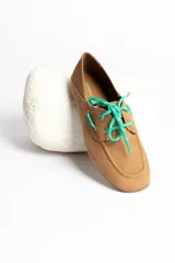 Mocasines color marrón claro con cordones y detalle de costuras en la puntera.