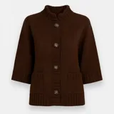 Saco tejido color marrón, con cuello alto, mangas tres cuartos amplias y cierre frontal con botones.