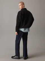 Campera negra de algodón regenerativo con cuello en punta clásico, puños con botones, cierre de cremallera, bolsillos de ojal, bolsillo con cremallera en el pecho, forro completo e insignia con el logo de Calvin Klein en el pecho.