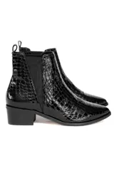 Botín negro de cuero charol con textura tipo cocodrilo, elásticos laterales, punta fina y taco cuadrado bajo.
