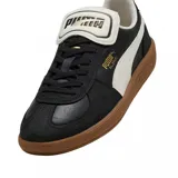 Championes Puma Palermo Premium, color negro con detalles en blanco y suela marrón.