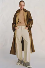 Jeans de tiro medio color beige, corte relaxed leg y largo al tobillo. Cuentan con cinco bolsillos y bajo con vuelta a contraste en gris. Cierre frontal con cremallera y botón.