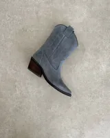 Bota corta de gamuza negra con bordados en hilo negro en la caña y puntera. Taco cuadrado y bajo.