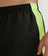 Bermuda deportiva negra con cintura elástica ajustable, recortes en gris en los laterales y vivos en amarillo flúor.