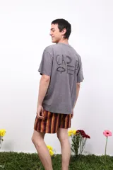 Remera gris de algodón con cuello redondo y manga corta. Estampa pequeña en el frente y grande en la espalda. Corte clásico.