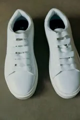 Championes blancos de cuero con cordones y suela gruesa.