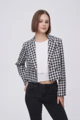 Blazer corto con estampado a cuadros blancos y negros, solapas y cierre con dos botones.