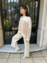 Sweater tejido color marrón con rayas horizontales blancas, cuello redondo y corte holgado.