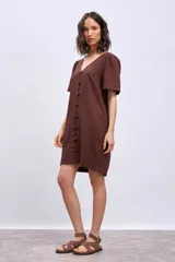 Vestido corto negro de lino con escote en V y abotonadura frontal.