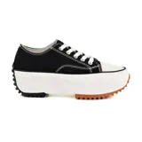 Zapatillas deportivas urbanas negras con puntera blanca y suela gruesa con detalles marrones.