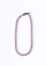 Pulsera tennis de acero quirúrgico con zirconias rosadas engarzadas.