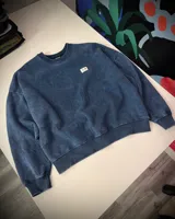 Buzo azul con efecto nevado gastado, corte oversized y cuello redondo.