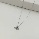 Conjunto de collar con dije en forma de ojo turco, elaborado en plata 925 y circonias, con cadena de 46 cm.