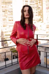 Chaqueta de cuero ovino color negro, con cierre frontal asimétrico y cuello mao.