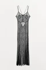 Vestido largo semitransparente de encaje negro, con escote en pico, tirantes finos dobles, abertura en la espalda y cierre con botones ocultos.