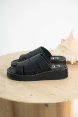 Sandalias marrones de gamuza con plataforma y tiras con aberturas.