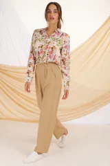 Camisa de estampado floral en tonos crudos y azules, con cuello y botones frontales.