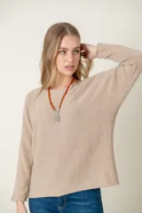 Sweater de lana color beige, de corte holgado y mangas largas.